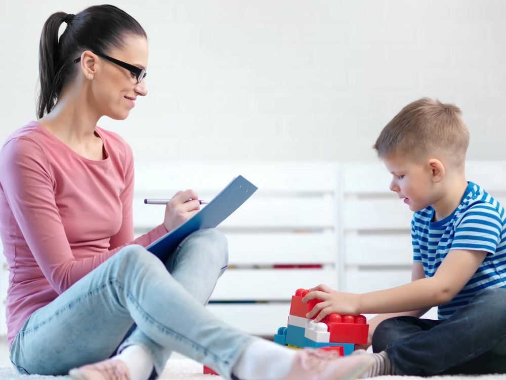 A parent and child playing together on the floor